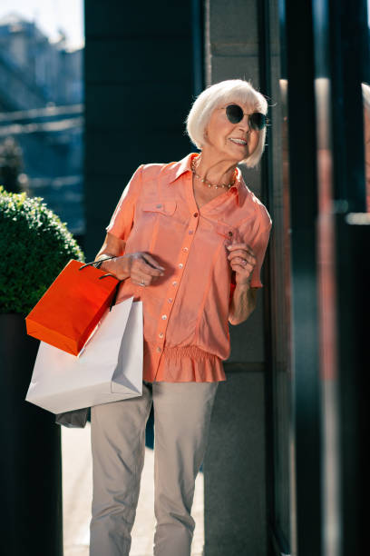 istock Happy pensioner bending head on one side while being outdoors 1165161739