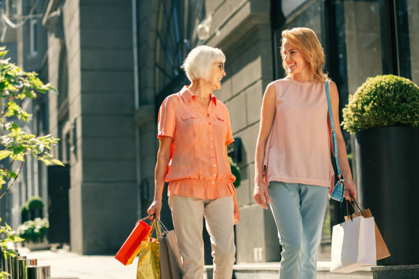 istock Delighted ladies smiling after going shopping 1165163589