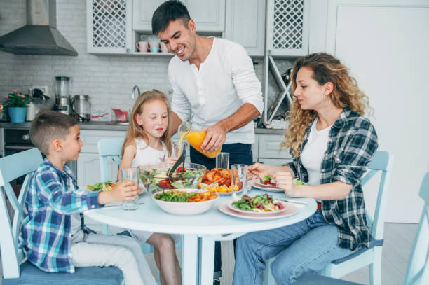 istock Young family eating together at home. 1165167629