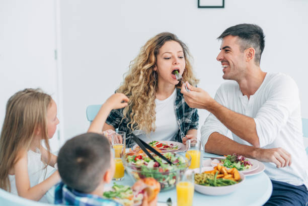 istock Young family eating together at home. 1165167630