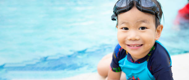 asian boy child godendo in piscina - child exercising little boys toddler foto e immagini stock