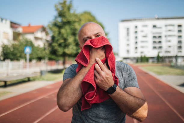 istock Senior man wiping his sweat after a running session 1165168275