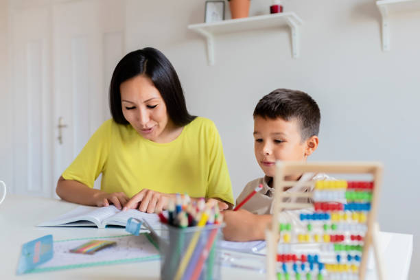 istock Mother Helping Her Little Son With Homework 1165173210