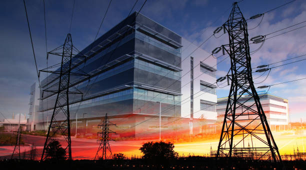 Office Buildings Energy Supply Photo montage of two electric pylons with a large industrial building in background buzbuzzer stock pictures, royalty-free photos & images