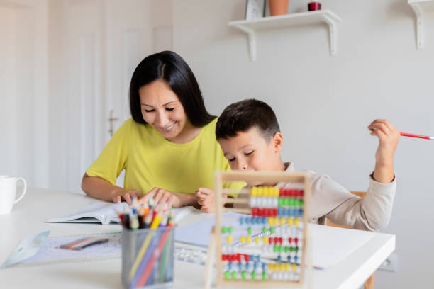 istock Mother Helping Her Little Son With Homework 1165173224