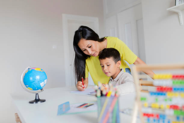 istock Mother Helping Her Little Son With Homework 1165173951