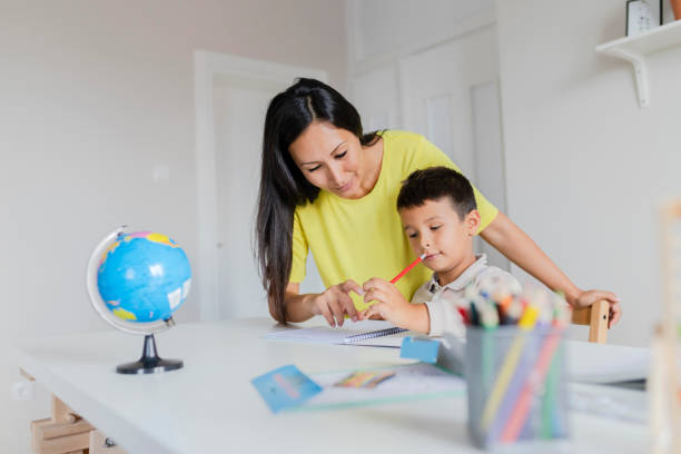 istock Mother Helping Her Little Son With Homework 1165174808