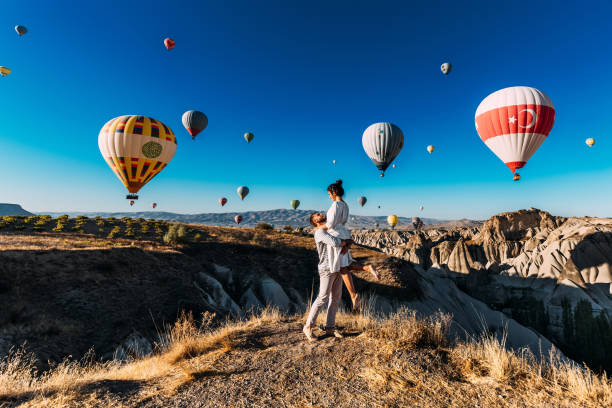 Happy couple in Cappadocia. The man proposed to the girl. Honeymoon in Cappadocia. Couple at the balloon festival. Couple travels the world. The Landscapes Of Cappadocia stock photo