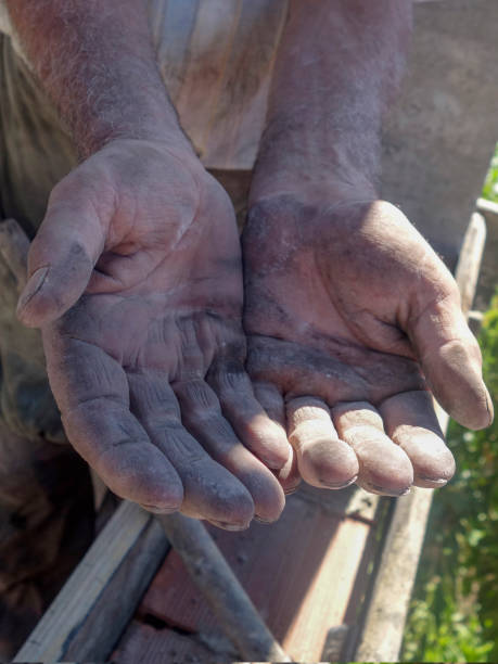 istock Old man is working wood with hammer - is building 1165177841
