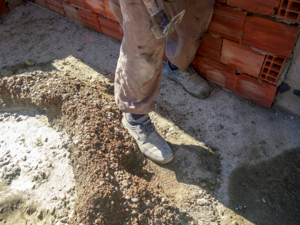 Old man is working wood with hammer - is building