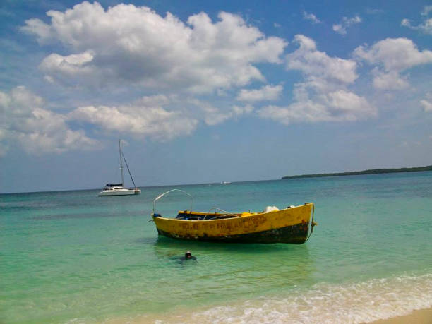 istock a small fisher boat at the beach 1165180069