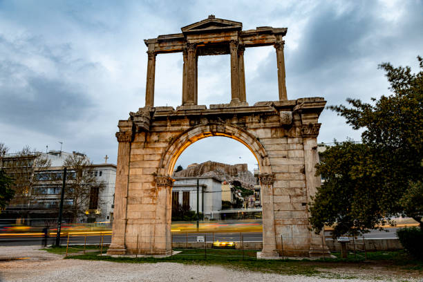 car trails behind hadrian gate in Athens stock photo