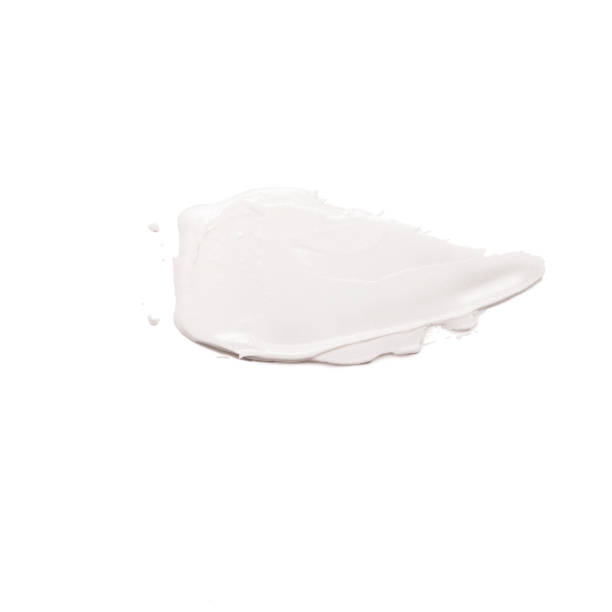 istock Moisturizing face cream smeared beige isolated on white background. 1165180404