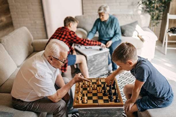 I would like you to learn me how to play Family event, kids playing chess with grandparents i love how you love me stock pictures, royalty-free photos & images