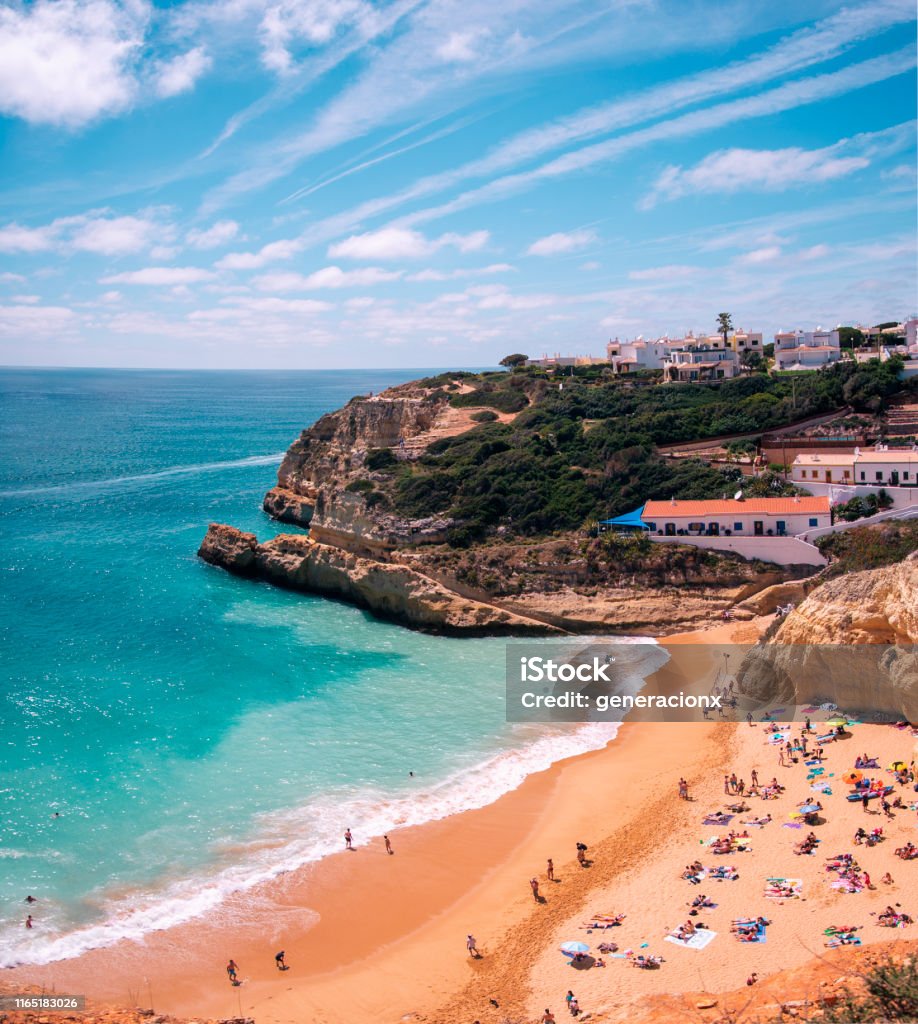 Beach in Algarve Blue turquoise beach in a sunny day in Portugal Alvor Stock Photo