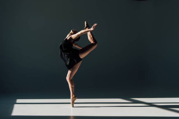 istock beautiful young ballerina dancing in sunlight 1165186119