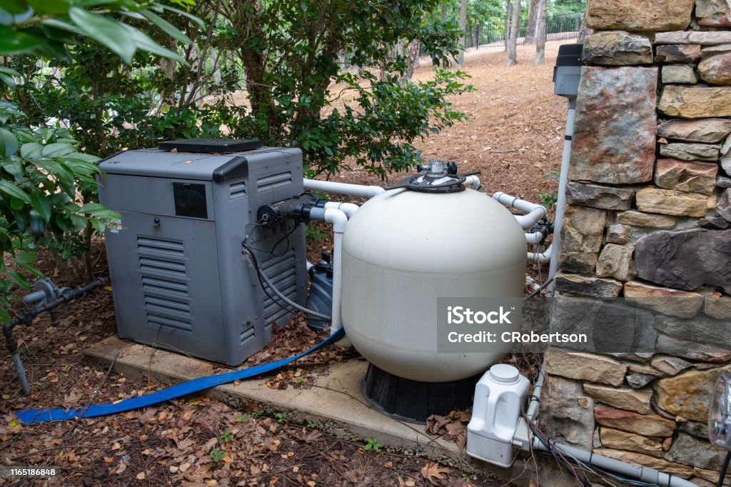 Residential Pool Pump and filtration system Pool pump and filtering equipment for maintaining a clean swimming pool Swimming Pool Stock Photo