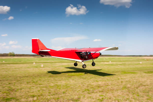istock Landing red small private aircraft on the airfield 1165187146