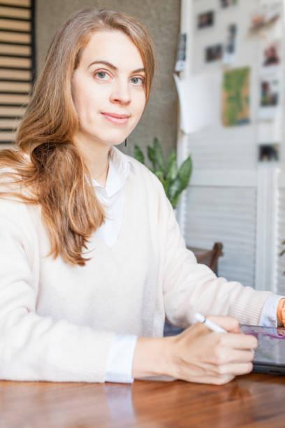 istock Smiling woman working with laptop gadget in office 1165188185