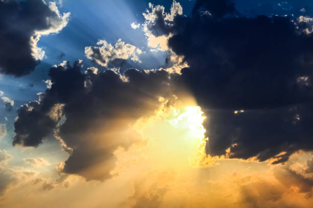 istock Blue yellow sky with clouds and god rays 1165188359