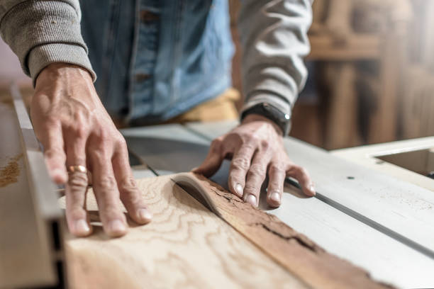 istock Electric saw cutting wood board. Man working at carpentry workshop 1165189309