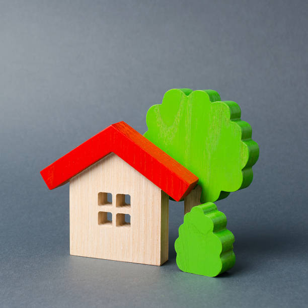 istock Wooden house and trees. Environmentally friendly and environmentally friendly home. Modern technology in construction. Quiet and cozy, comfortable affordable housing. Housing in the suburbs. 1165190908