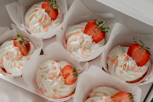 istock cupcakes decorated with cream and strawberries 1165192476