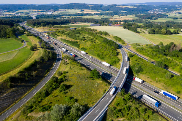 istock Semi Trucks on Highway Intersection, Aerial View 1165194429