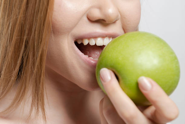 istock Woman with Green Apple 1165195667