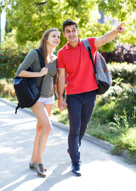 istock Happy couple is walking around park together 1165196344
