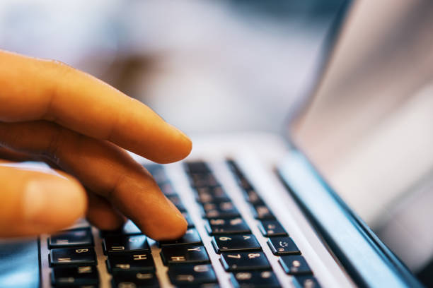 istock Sideview of businessman using laptop on desktop 1165198000