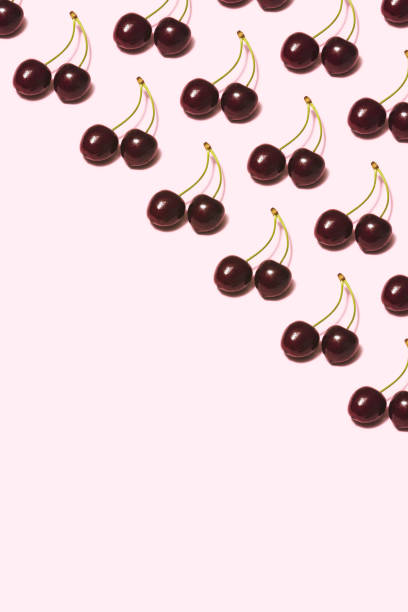 istock Cherry repetitive flat lay on pink background 1165199157