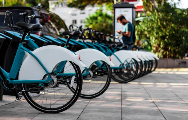 istock multiple stationed bikes for rent / someone is about to hire one. 1165199399