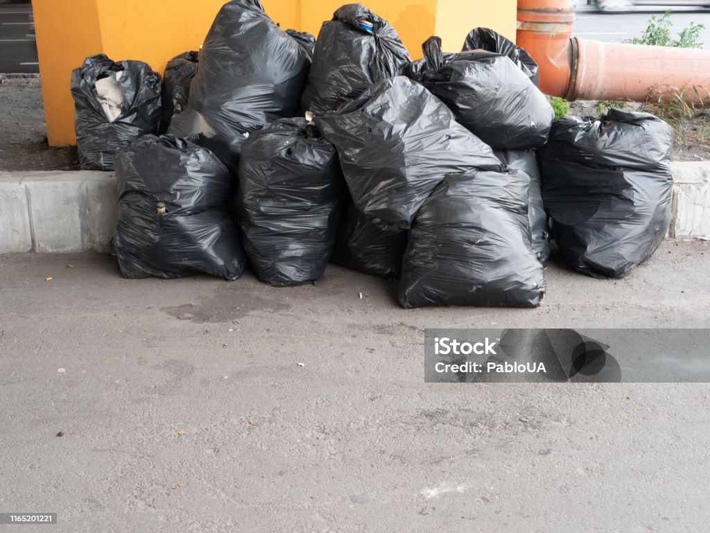 Big Pile Of Black Plastic Garbage Trash Bags Stock Photo - Download Image  Now - Bag, Black Color, City - iStock