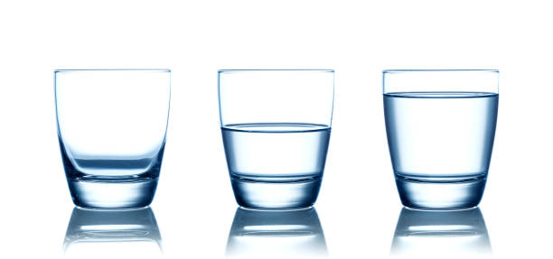 istock Empty,half and full water glasses . Isolated on white 1165202633