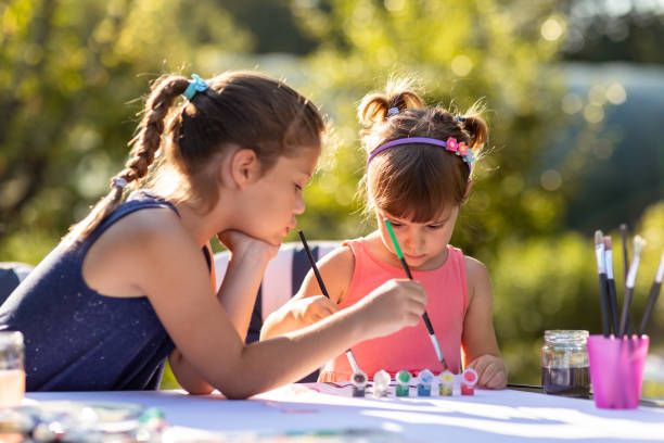 istock Children Drawing Picture Outdoors in Summer 1165204590