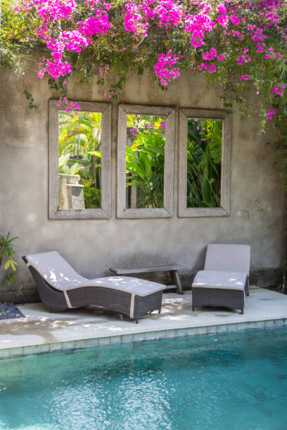 istock Two deck chairs next to the swimming pool, tropical vacation 1165209164