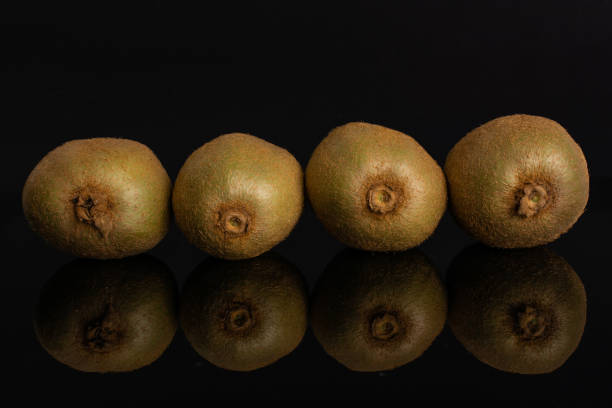 istock Fresh green kiwi isolated on black glass 1165212479