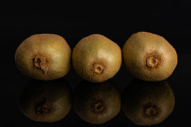 istock Fresh green kiwi isolated on black glass 1165212480