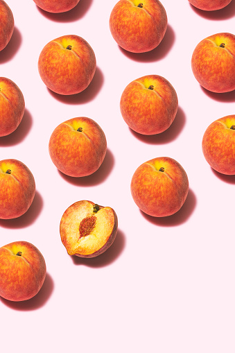 Peaches flat lay on pink background