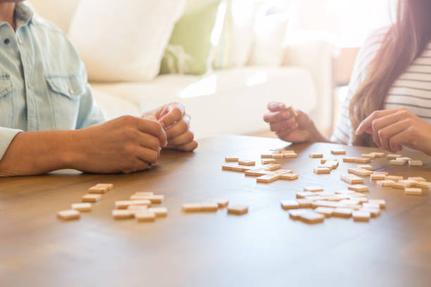 istock Unrecognizable couple play word game together at home 1165213506