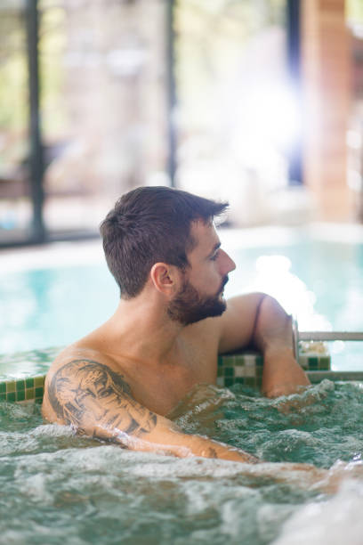 istock Man relaxing in hydro massage pool 1165214348
