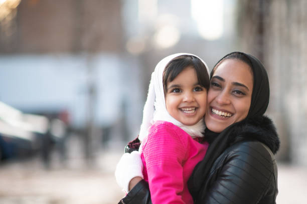 istock Muslim mother and daughter outside 1165214611