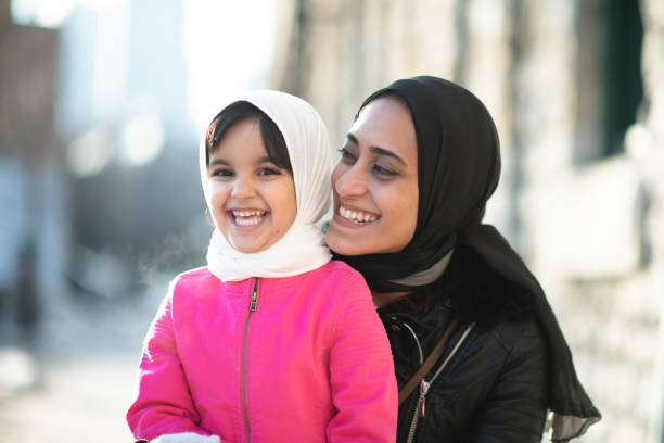 Muslim mother and daughter outside