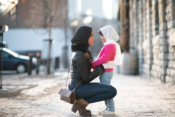 istock Muslim mother holding her daughter 1165214655