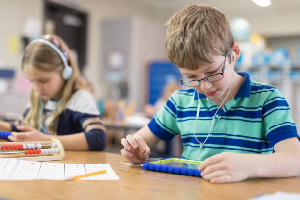 istock First grade boy working on a digital tablet at his desk 1165215315