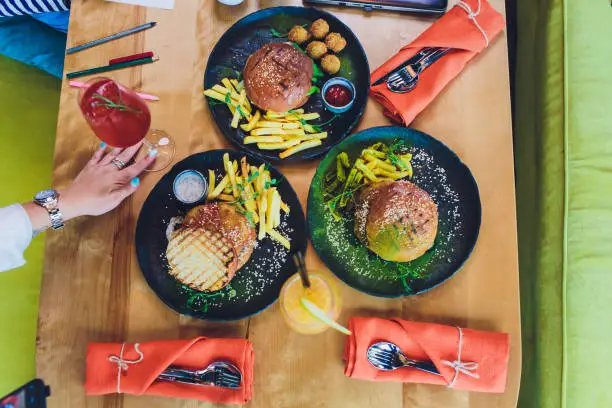 Red, green,black mini burgers with quinoa and vegetables