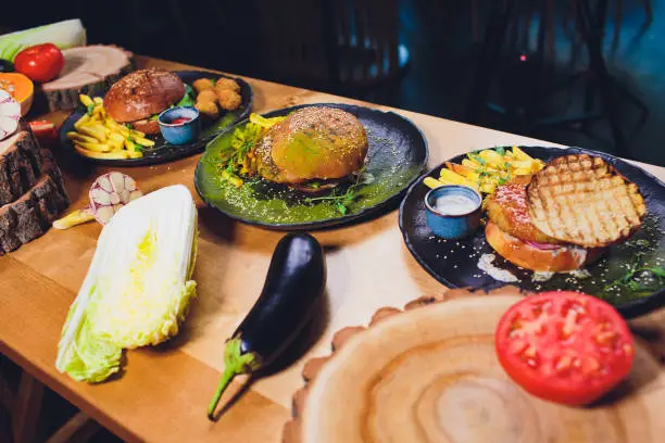 Red, green,black mini burgers with quinoa and vegetables