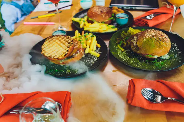 Red, green,black mini burgers with quinoa and vegetables