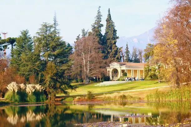 Beautiful landscape of Concha y Toro winery, famous tourist spot of Santiago. The lake reflects the mansion and the surrounding trees.